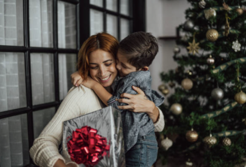 what to know about taking out a holiday loan featured image woman smiling while hugging son